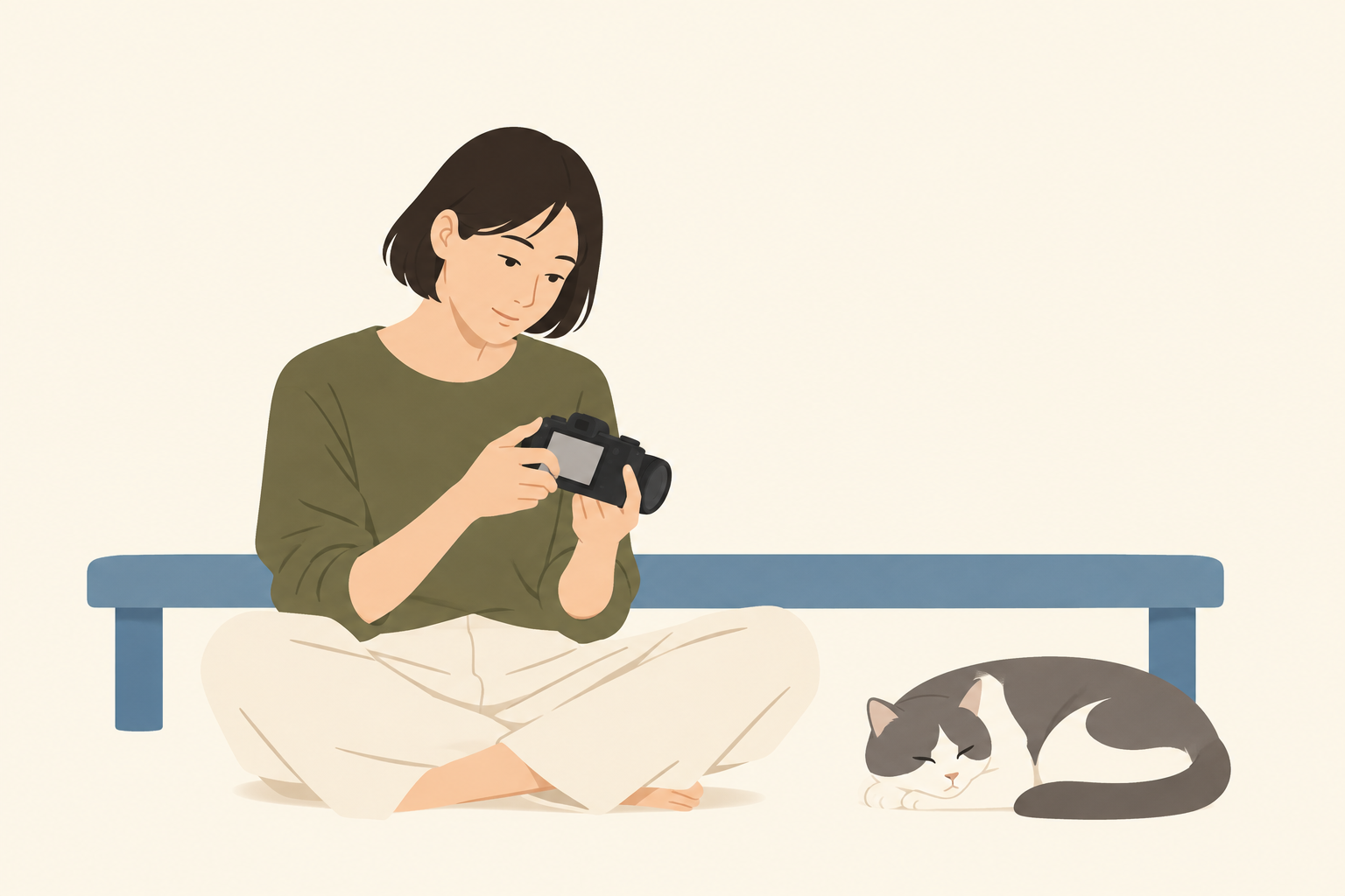 自宅で猫がくつろぐ横で、カメラの背面画面を見返す人のイメージ